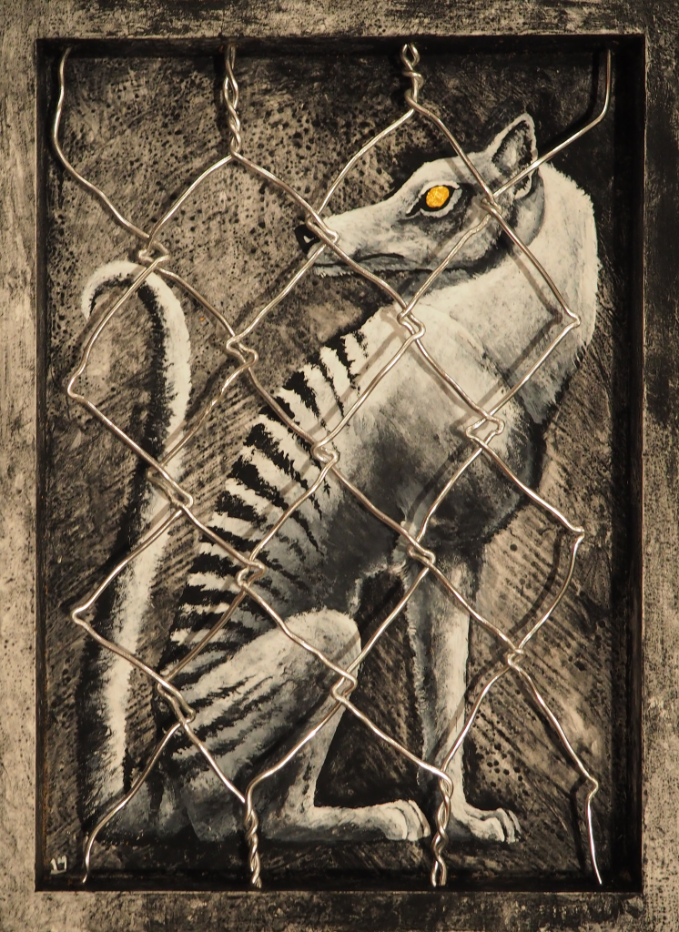 a traditional art piece painted on an inset shadowbox, showing a golden-eyed thylacine in black and white composed of sharp angles sitting confined within the box, which is painted to look like concrete. wirework resembling a chainlink fence sits over the painting
